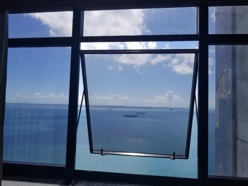 a view of the ocean from a window at Sol Vitória Marina - Mahi Mahi - Corredor da Vitória in Salvador