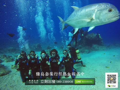 a group of people taking a picture of a fish at Toong Hsiang Hotel in Green Island
