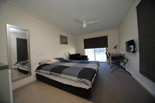 a bedroom with a bed and a desk and a window at Black Rock Inn in Blackwater