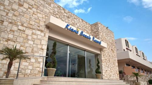a building with a sign on the side of it at Kiani Beach Resort Family All Inclusive in Kalyves