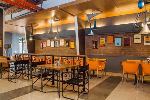 a restaurant with tables and chairs in a room at Max Hotels Jabalpur in Jabalpur