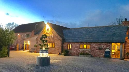 a brick house with a tree in front of it at The Pig Inn in Snaith