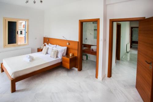a bedroom with a large bed and a bathroom at Coralli Villas in Coral Bay