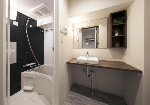 a bathroom with a sink and a toilet at e-stay ebisu in Osaka