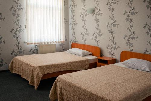 a hotel room with two beds and a window at Vershnyk in Cherkasy