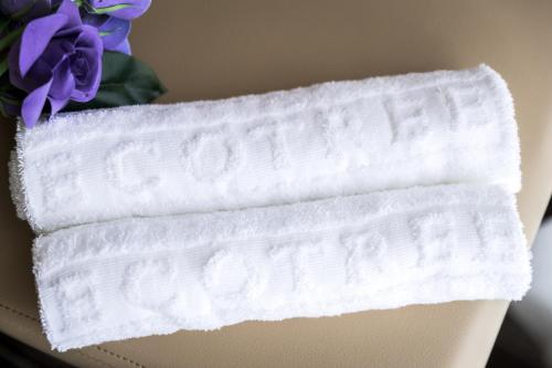 a white bandana on the back of a chair with purple flowers at Eco Tree Hotel Causeway Bay in Hong Kong