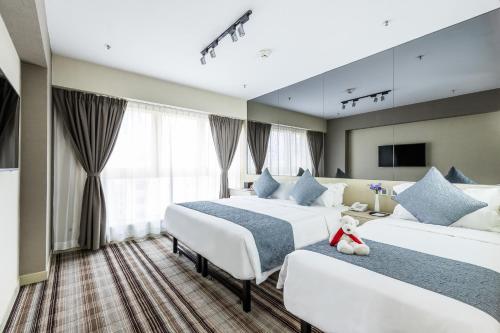 Postel nebo postele na pokoji v ubytování Eco Tree Hotel Causeway Bay