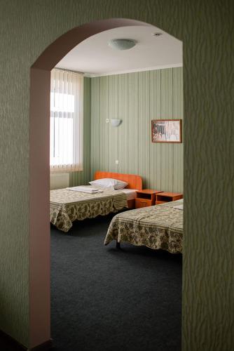 a hotel room with two beds and a mirror at Vershnyk in Cherkasy