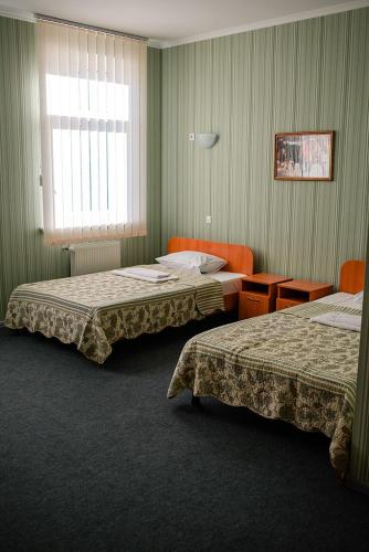 a hotel room with two beds and a window at Vershnyk in Cherkasy