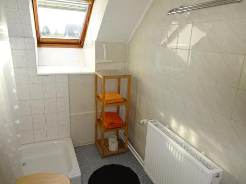 a bathroom with a tub and a toilet and a window at Ferienwohnung Kretschmer in Dessau