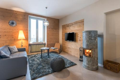 a living room with a couch and a fireplace at la roche gauthier 4 personnes in Gérardmer