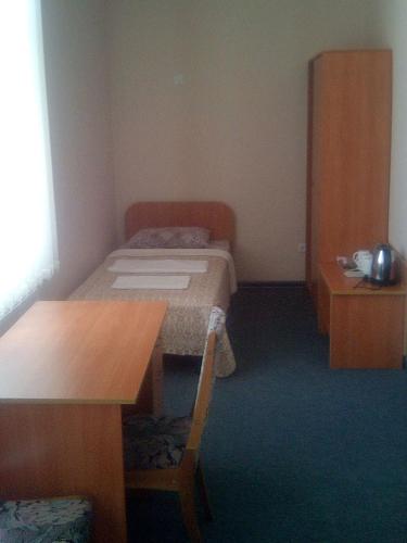 a small room with a bed and a desk at Vershnyk in Cherkasy