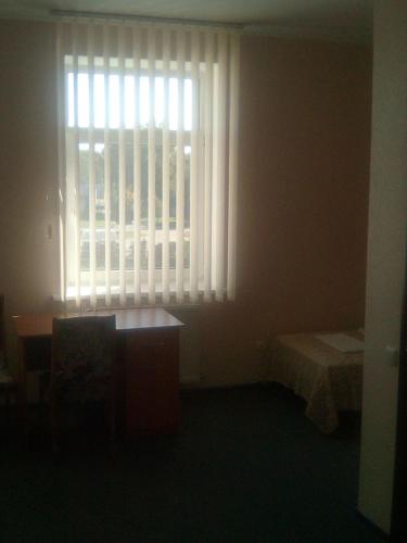 a room with a window and a desk and a table at Vershnyk in Cherkasy