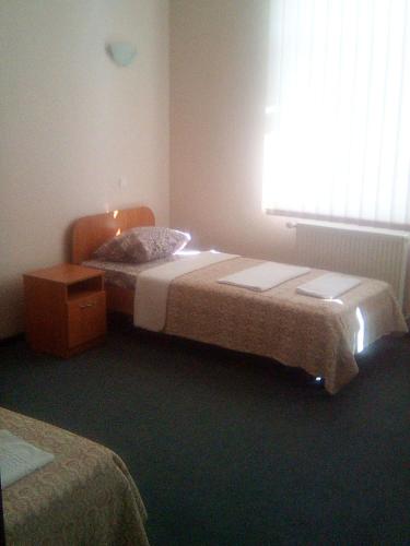 a bedroom with two beds and a window at Vershnyk in Cherkasy