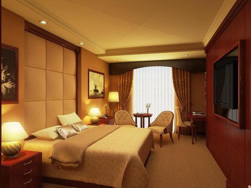 a hotel room with a bed and a television at Brijwasi Royal in Mathura