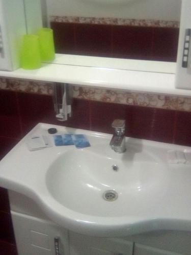 a bathroom with a white sink and a mirror at Vershnyk in Cherkasy