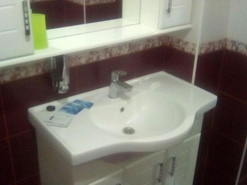 a bathroom with a white sink and a mirror at Vershnyk in Cherkasy