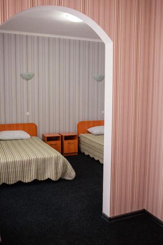 a hotel room with two beds and an archway at Vershnyk in Cherkasy
