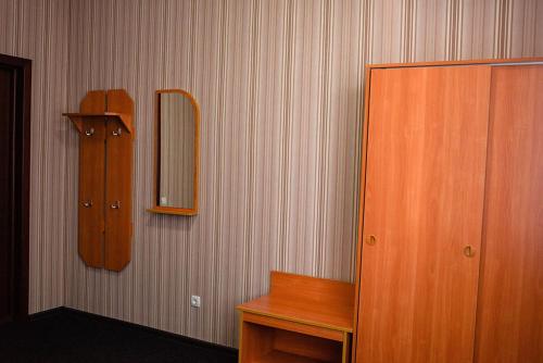 a bathroom with a wooden cabinet and a mirror at Vershnyk in Cherkasy