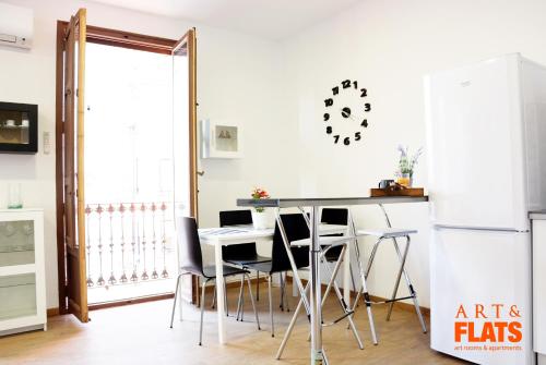 a kitchen with a table and chairs and a refrigerator at Calle Cuenca in Valencia