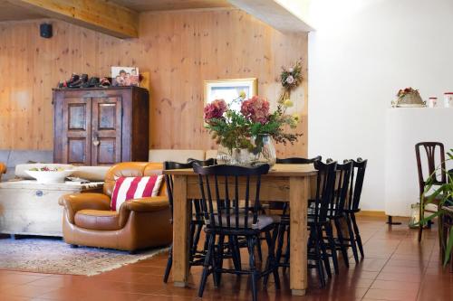 a living room with a table with chairs and a couch at Albergo Stelvio in Bormio