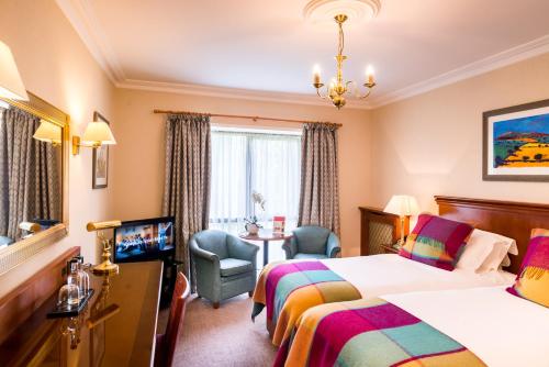 a hotel room with two beds and a tv at Parkway Hotel & Spa in Newport