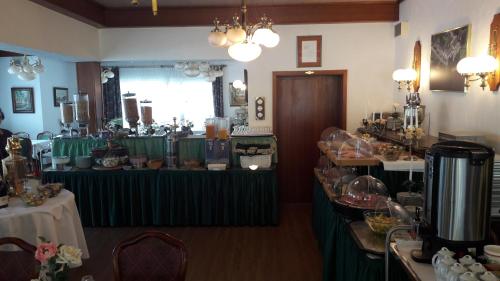 a room with a table with food and wine glasses at Hotel Seemöwe in Simmerath