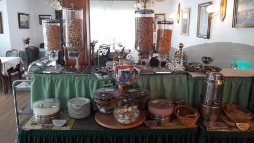 a table topped with lots of pots and pans at Hotel Seemöwe in Simmerath