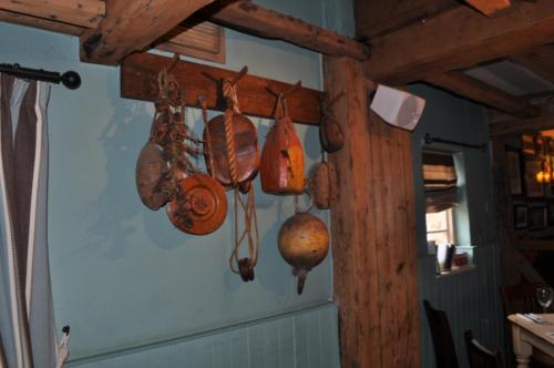 a bunch of utensils hanging on a wall at The Smugglers Inn in Weymouth