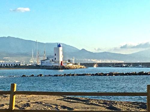a view of a body of water with a lighthouse at CN-340 Suites in Estepona