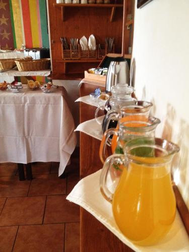 a row of pitchers of orange juice on a table at Pension Alfa & Whisky Pub in Tábor