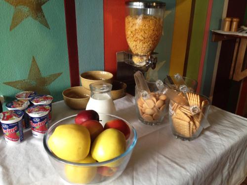 a table with a bowl of apples and other food at Pension Alfa & Whisky Pub in Tábor