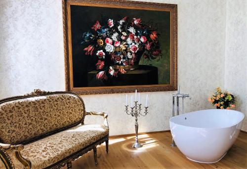 a room with a painting of a vase of flowers at Hotel Panství Dlouhá Lhota in Dlouhá Lhota