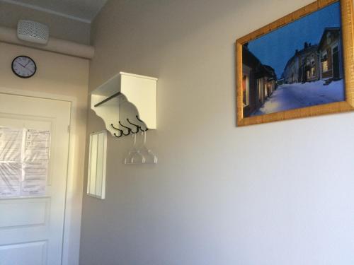 a wall with a hand hanging from a lightswitch at Imatran Portti in Imatra