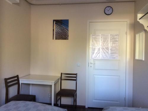 a bedroom with a desk and a clock on the wall at Imatran Portti in Imatra