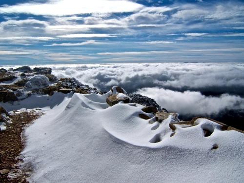 a view of a mountain with snow and clouds at CN-340 Suites in Estepona