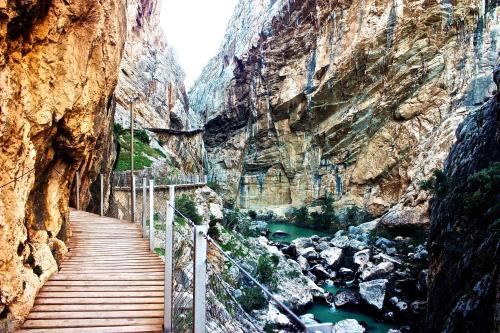a staircase leading into a canyon with green water at CN-340 Suites in Estepona