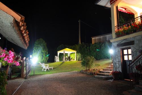 a backyard at night with a gazebo at Casavacanzedezza in Montecalvo Versiggia
