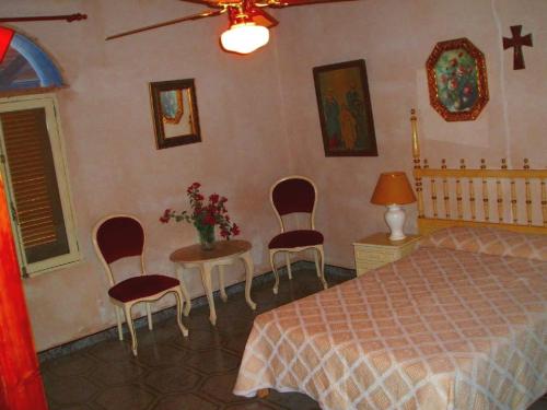 a bedroom with a bed and a table and chairs at Can Bril in Campos