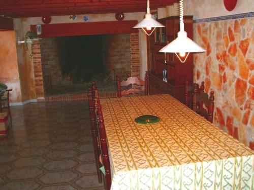 a dining room with a table and a fireplace at Can Bril in Campos