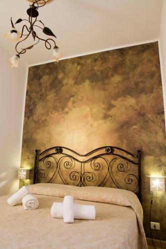 a bedroom with a bed with two towels on it at Villa Anna in Selva di Fasano