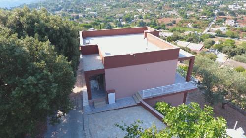 an aerial view of a house on a hill with trees at Villa Anna in Selva di Fasano