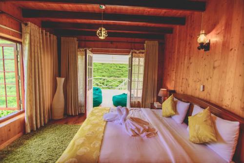 a bedroom with a bed in a room with a window at Sarah Cottage Nuwara Eliya in Nuwara Eliya