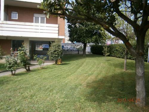 a yard in front of a house with a tree at Albergo Guido Reni in Turin