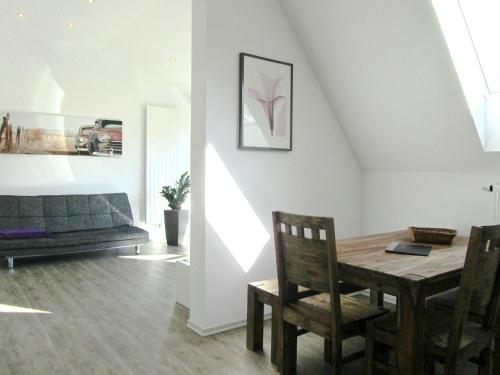 a living room with a table and a couch at Dilger Apartments in Rust