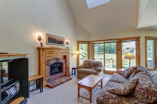 a living room with a couch and a fireplace at Jay Peak Townhouse in Jay