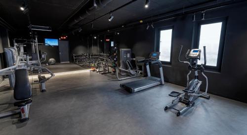 a gym with several exercise equipment in a room at Radisson Hotel & Suites Amsterdam South in Amstelveen