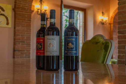 two bottles of wine sitting on a table at Villa Talosa in Montepulciano