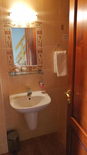 a bathroom with a sink and a mirror at Penzión Manín in Považská Bystrica