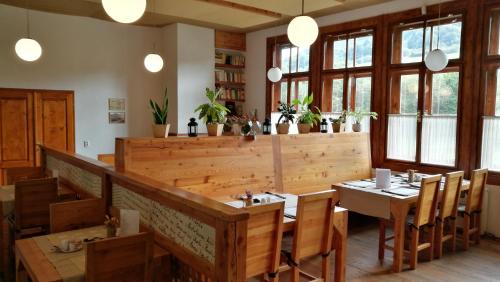 a dining room with wooden tables and chairs at Penzión Manín in Považská Bystrica